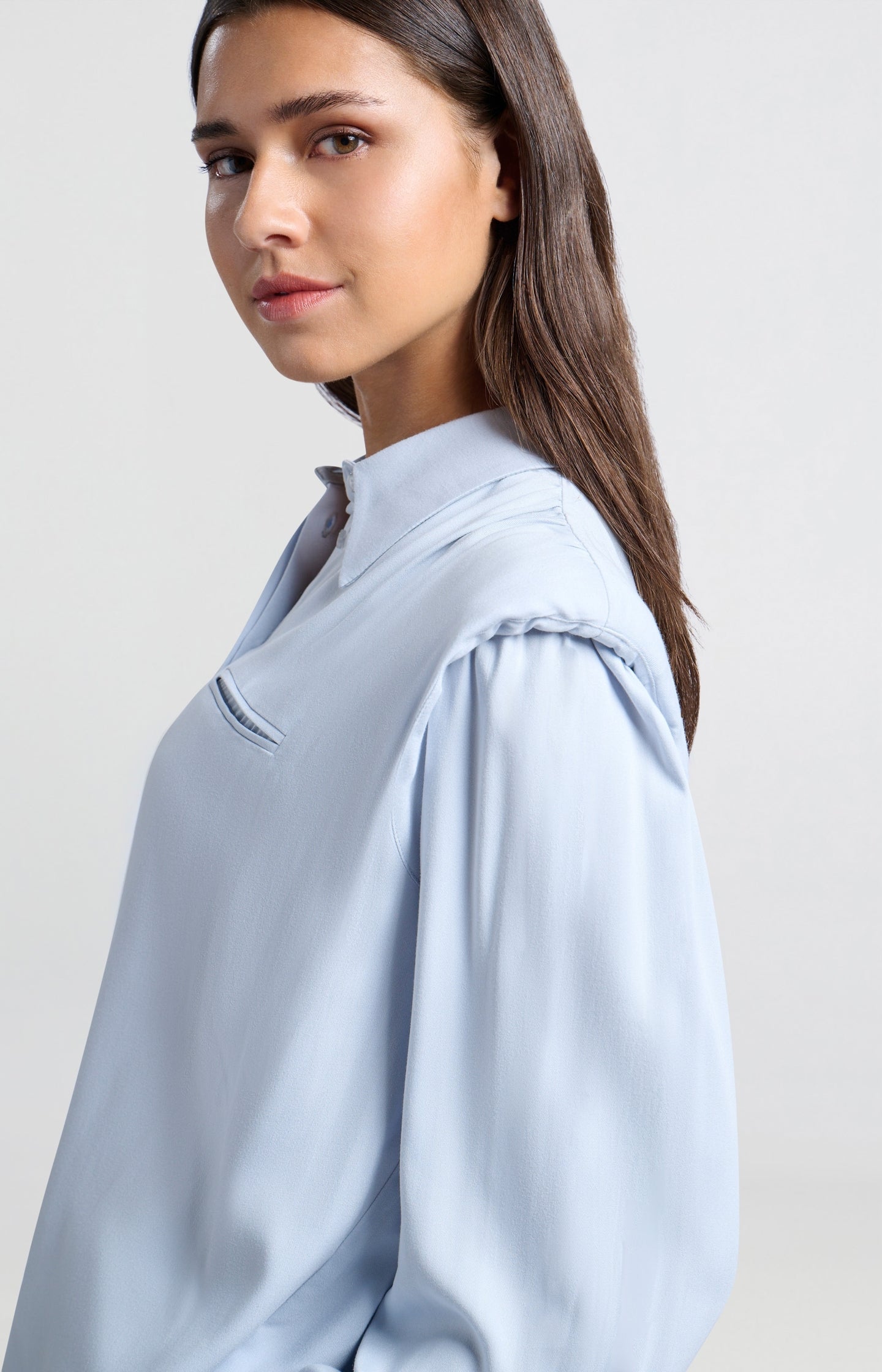 Blouse with long sleeves, buttons and shoulder pads